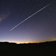 A long exposure photo of one of Starlink's satellites orbiting in the galaxy overhead